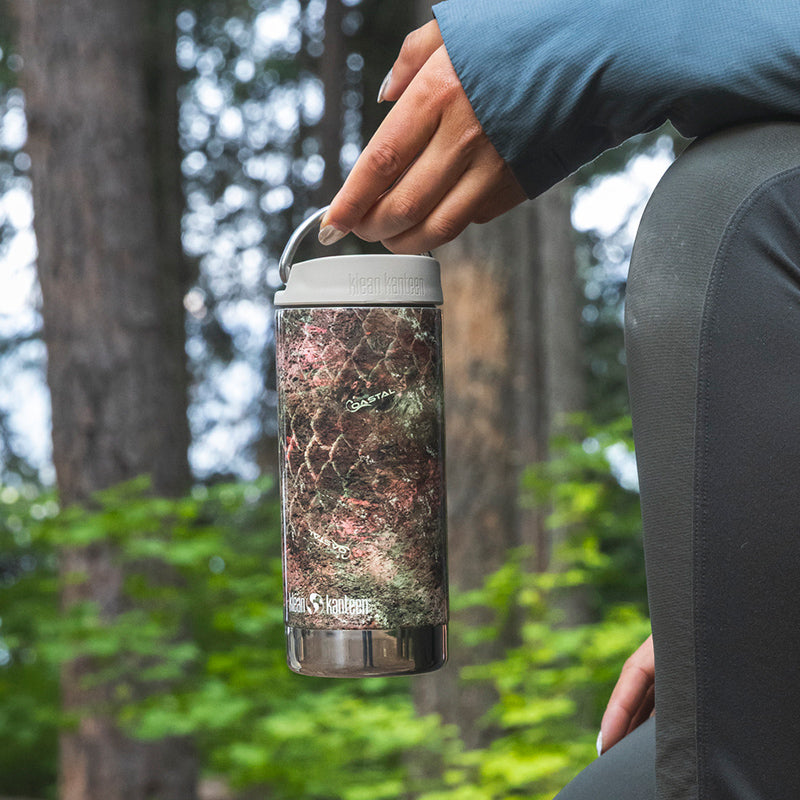 12oz-tkwide-with-cafe-cap-mossy-oak-b8 12oz_tumbler_mossyoak_rainbowtrout_hand_closeup_square.jpg
