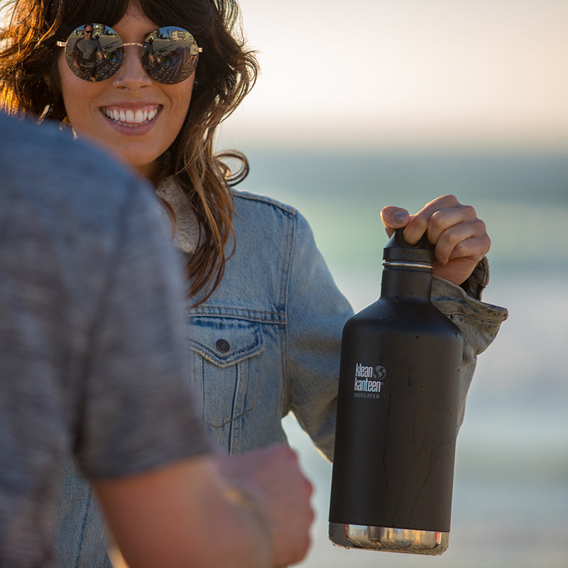 64oz-classic-with-loop-cap-g2 64oz_insulated_classic_black_beach_girl_hand_square.jpg