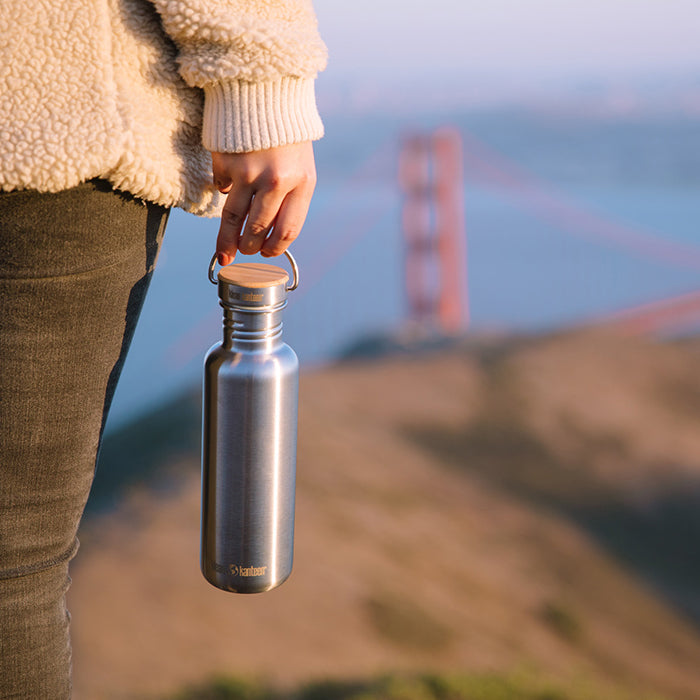 27oz-reflect-with-bamboo-cap-b6 K27SSLRF-BS-BAMBOO_reflect_bottle_bridge_lifestyle.jpg